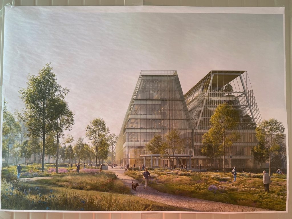 Rendu architectural représentant la future BEIC. Le bâtiment se compose de deux grandes nefs vitrées et métalliques en forme de volumes trapézoïdaux, reliées au rez-de-chaussée. L'ensemble est intégré dans un parc paysager avec des allées, des arbres et des plantations sauvages. Des promeneurs et un maître-chien sont représentés au premier plan.
